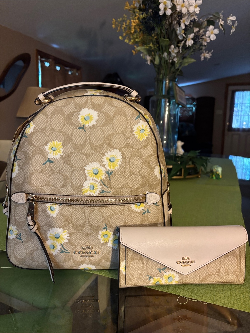 Coach Beige Signature Daisy Backpack with matching wallet.
